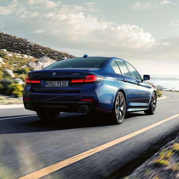 Driving dynamics BMW 5 Series Sedan G30 Driving dynamics BMW 5 Series Sedan G30 Phytonic Blue three-quarter rear view driving