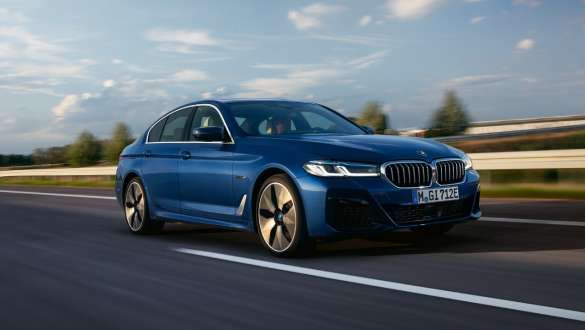 BMW 5 Series Sedan Plug-in hybrid 2021 G30 three-quarter front view driving BMW 5 Series Sedan Plug-in hybrid 2021 G30 three-quarter front view driving on the street
