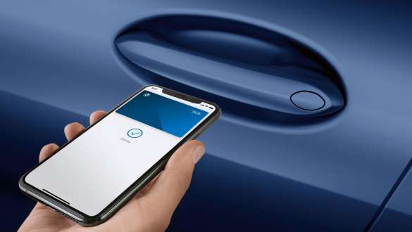 Digital Key BMW 8 Series Convertible G14 LCI Facelift 2022 Hand holding smartphone in front of car door Digital Key BMW 8 Series Convertible G14 LCI Facelift 2022 close-up