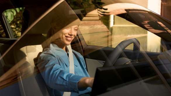 BMW interior Woman on driver’s seat BMW interior Woman on driver’s seat smiling