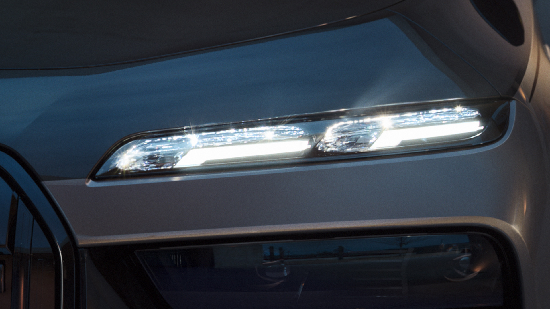 BMW crystal headlights Iconic Glow BMW M760e xDrive Sedan G70 BMW crystal headlights Iconic Glow BMW M760e xDrive Sedan G70 BMW Individual two-tone Black Sapphire metallic paintwork BMW Individual Dravite Grey metallic close-up with lights on