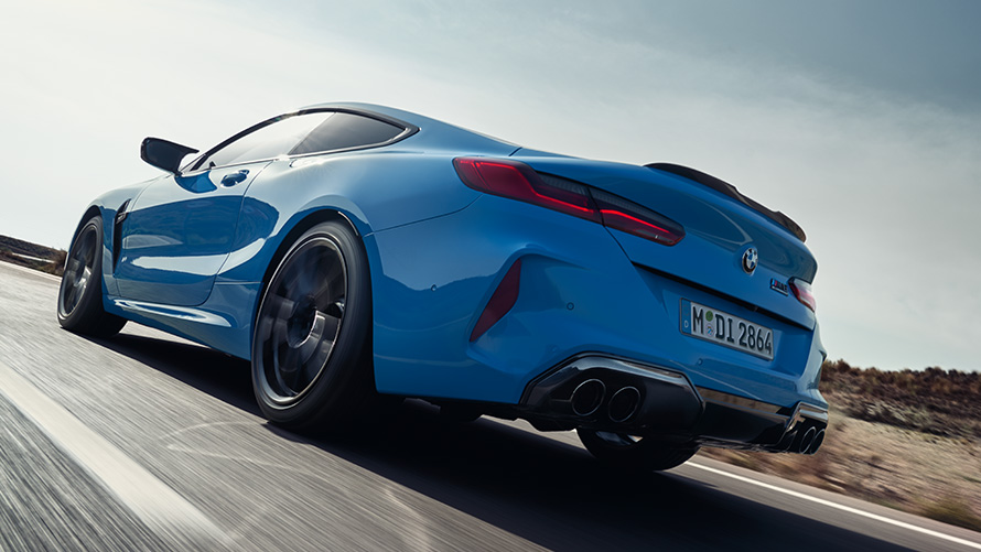 BMW M8 Competition Coupé F92 LCI 2022 three-quarter rear view driving BMW M8 Competition Coupé F92 LCI Facelift 2022 Daytona Beach Blue uni three-quarter rear view driving