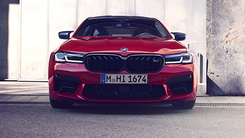 BMW M5 F90 three-quarter front view dirivng on the street BMW M Series BMW M5 F90 three-quarter front view dirivng on the street