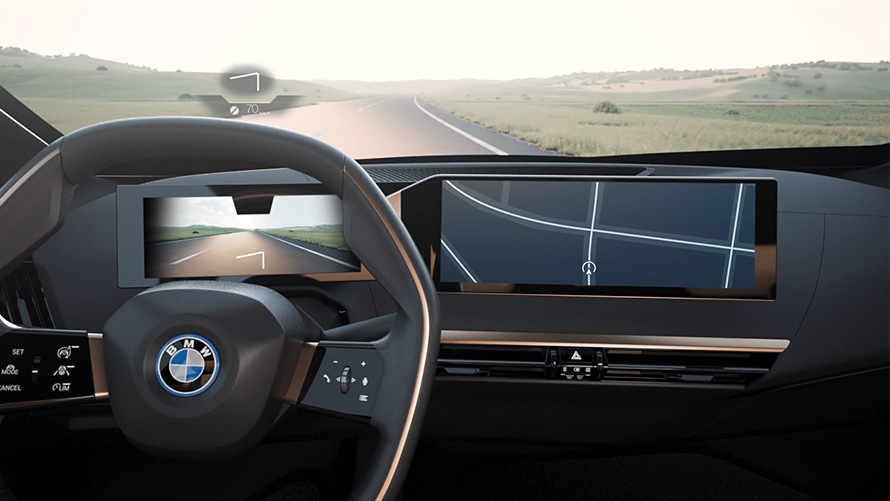 View from BMW interior with steering wheel and road View from BMW interior with steering wheel and road