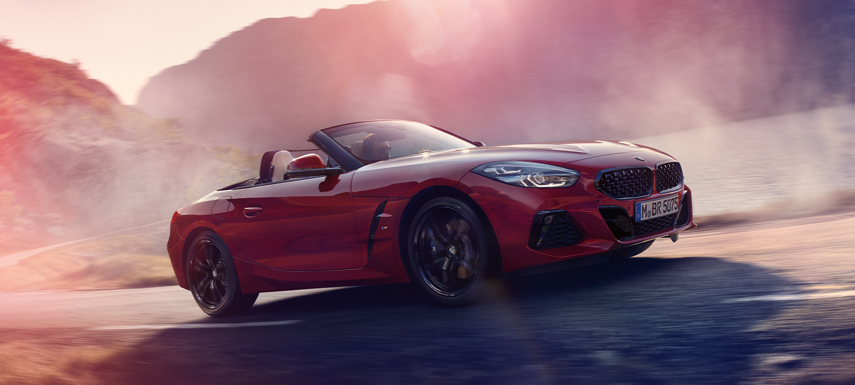 BMW Z4 M40i Roadster (G29) three-quarter side view driving BMW Z4 M40i Roadster (G29) three-quarter side view driving
