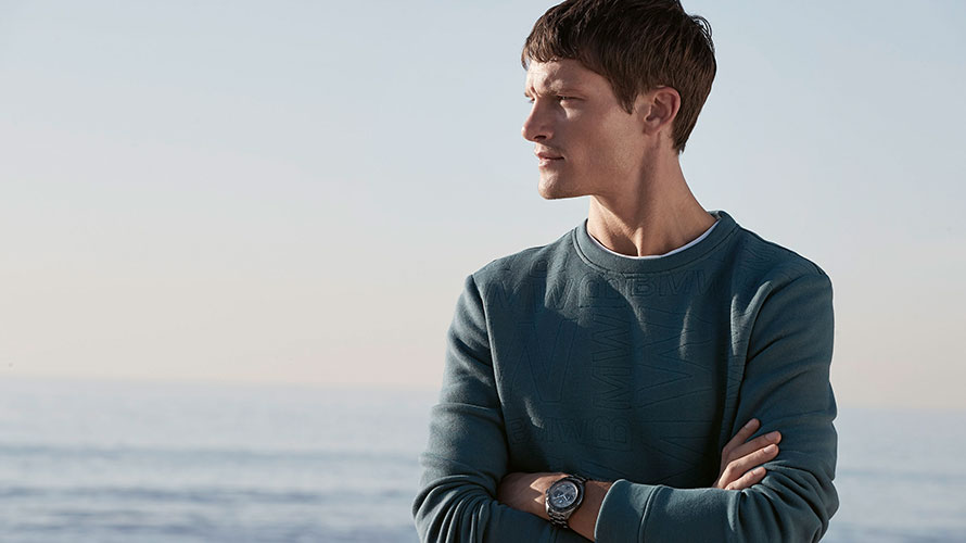 A young man is wearing the BMW Sweatshirt, Men.