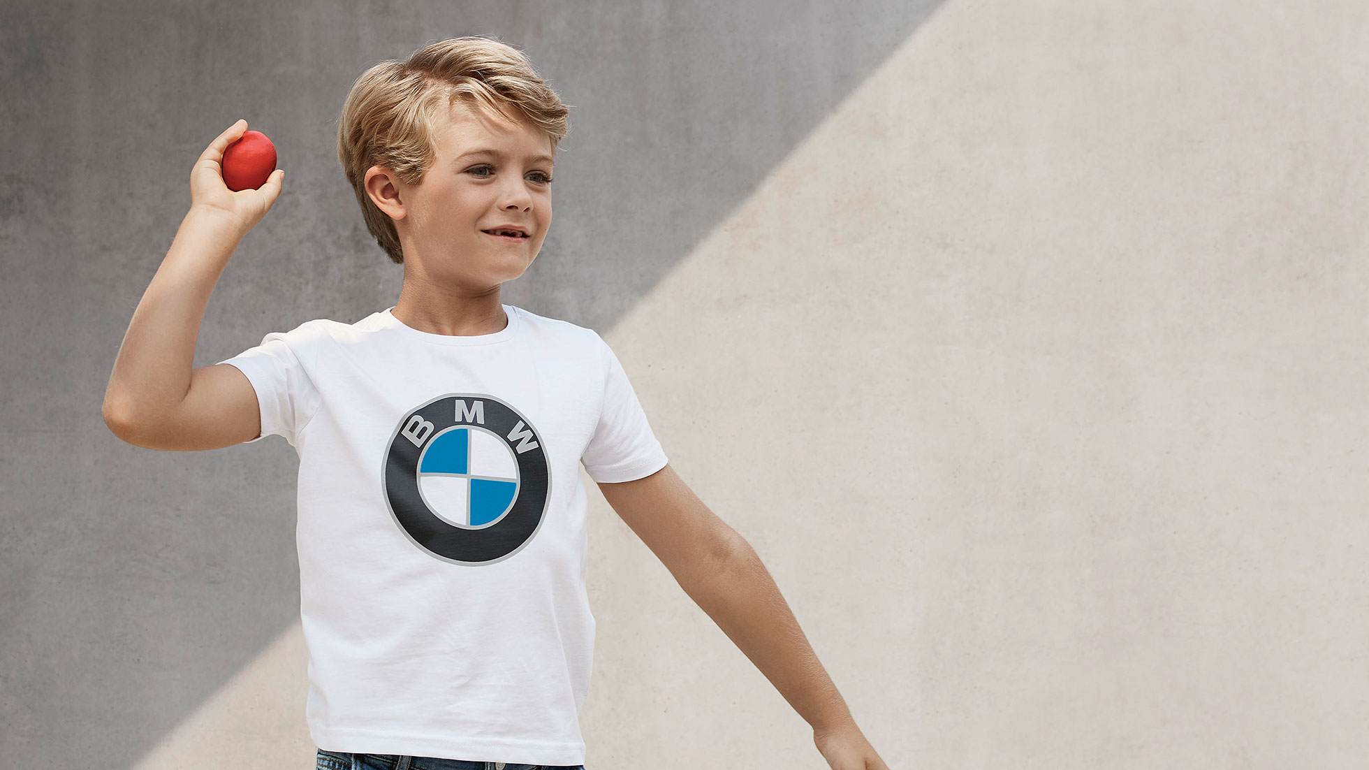 BMW Kids Collection. A boy is wearing pieces of the BMW Kids Collection.