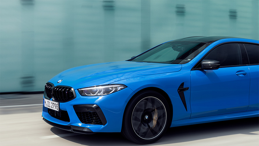 BMW M8 Competition Coupé F92 2019 BMW Individual Voodooblue three-quarter side view in section driving 