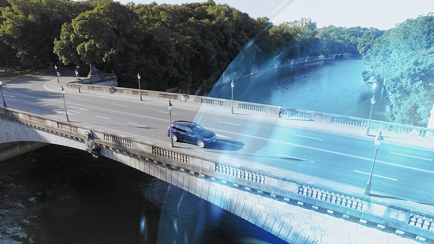 BMW vehicle driving over a bridge