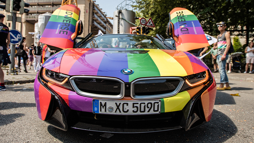 Diversity BMW Sustainability BMW Sustainability Diversity BMW vehicle front view in rainbow colors with open gull-wing doorsur